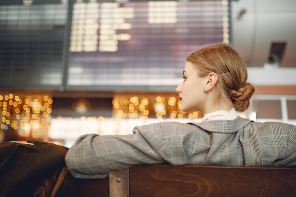 A business traveler checks flight information as rising costs reshape corporate travel