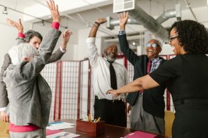 Diverse group of business professionals celebrating success in a lively meeting