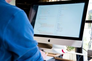 A developer writes code on a desktop screen, the kind of work AI coding agents now speed up.