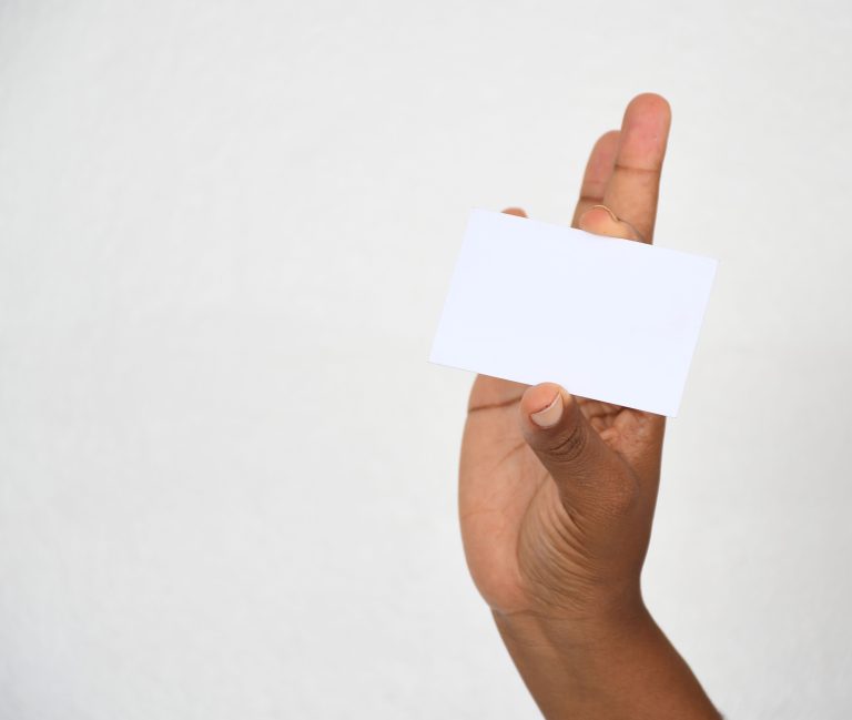 A close-up of a hand holding a blank card, ideal for copy space