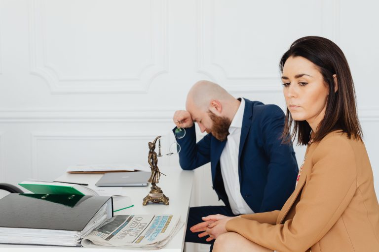 A couple consulting with their lawyer in an office setting, discussing divorce