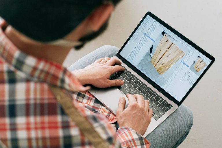 Person reviewing furniture photographs on a laptop