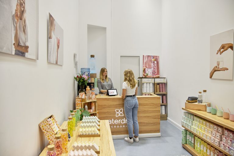 Person serving customers at a retail counter