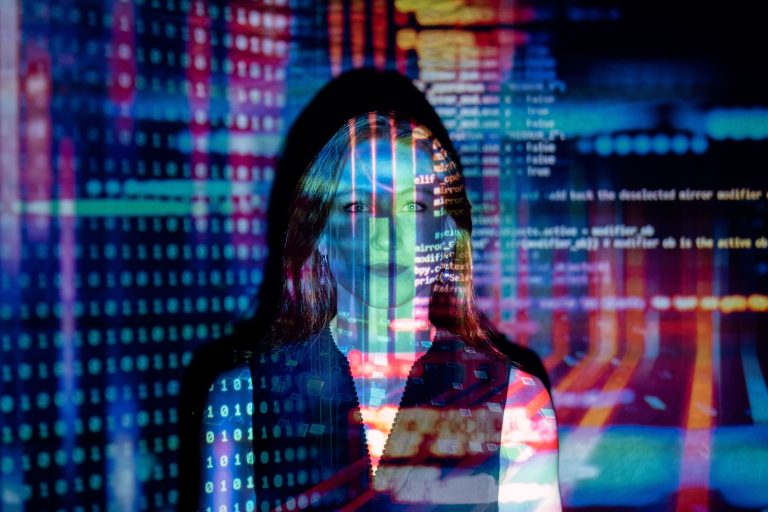 A woman with digital code projections on her face, representing technology and future concepts