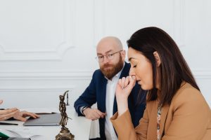 Lawyers in a serious discussion at a law office, showcasing concern and contemplation