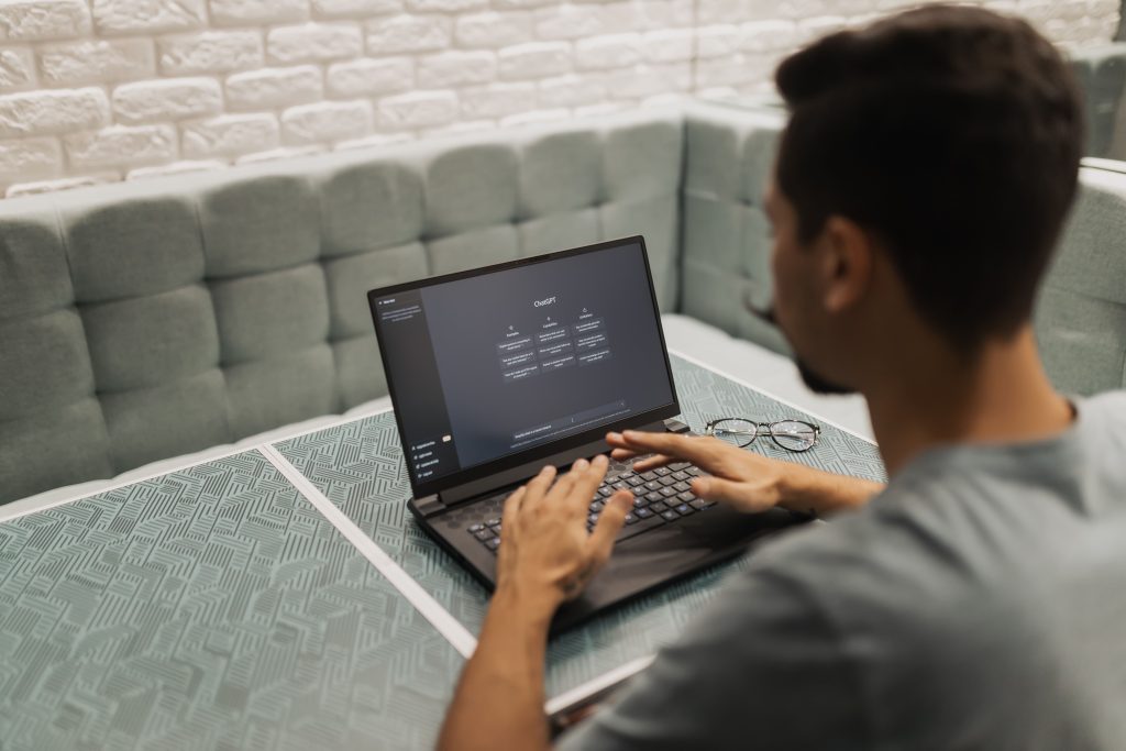 Person using a laptop displaying ChatGPT